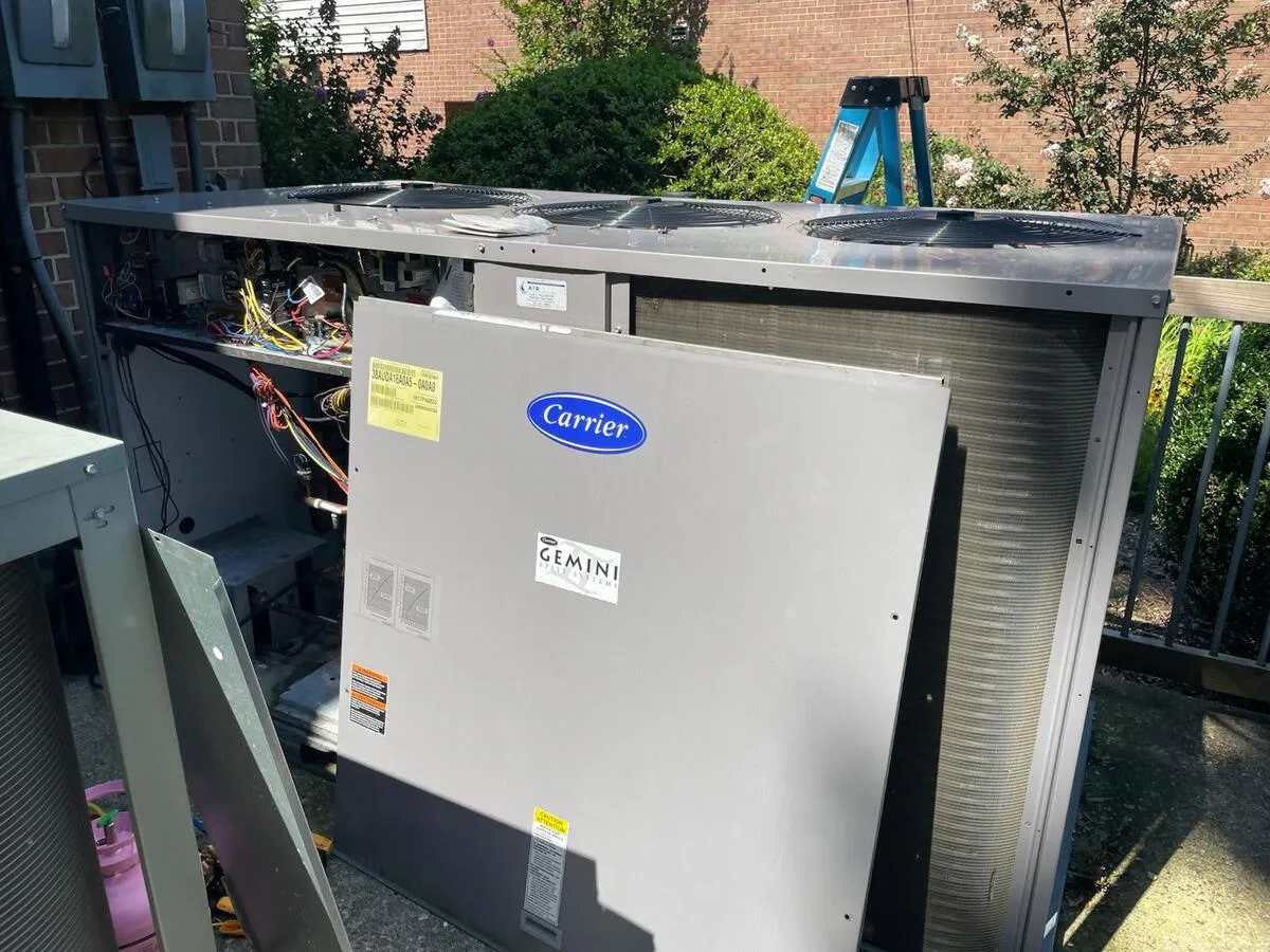 EG Mechanical technician servicing an HVAC unit